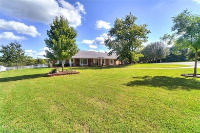 Large front yard with mature trees.