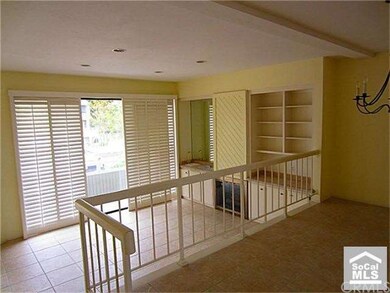 Living room features built-ins, fireplace, and pla