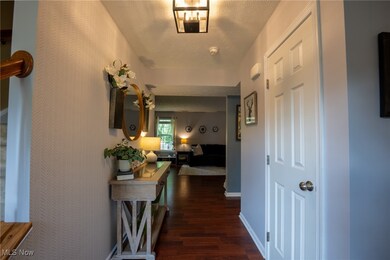 Hall with dark wood finished floors and a textured ceiling