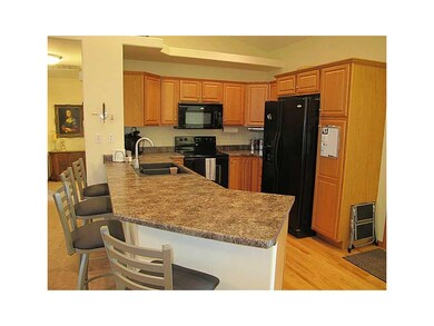 Kitchen. wood floors, refrigerator stays