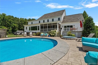 stamped concrete patio surrounds pool, hot tub and
