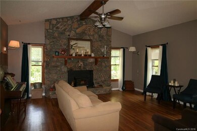 large stone fireplace/hickory floors in large livi