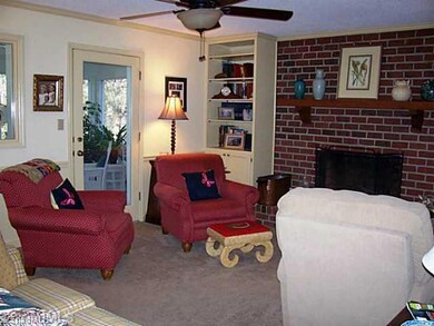 Den/Family/Great Room. Built in bookcases and storage w/great access to the 4 Seasons Sunroom. Wood burning fireplace.