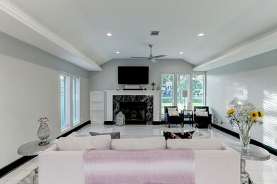 Open living room is well lit with plenty of seating area.