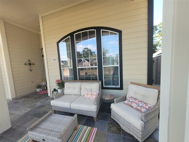 Inviting covered front porch sitting area!