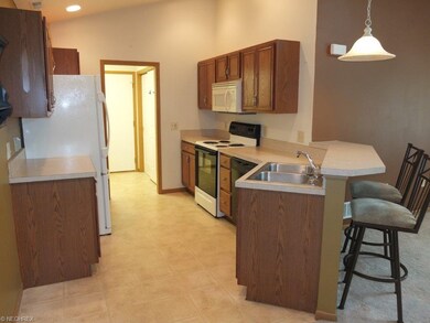 Fully applianced kitchen with breakfast bar.