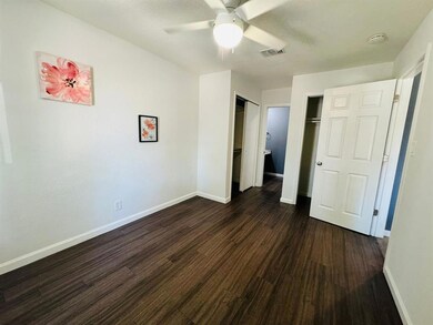 Unfurnished bedroom featuring dark wood-type floo