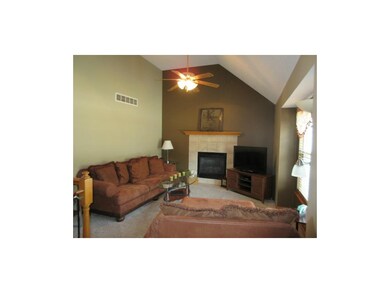 Great room has a gas log fireplace with an electri