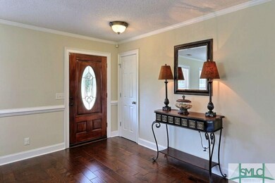 Foyer Entrance ~ Coat Closet ~ Wood Flooring ~ Crown Molding