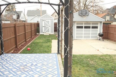 Pull through garage and an extra storage shed.