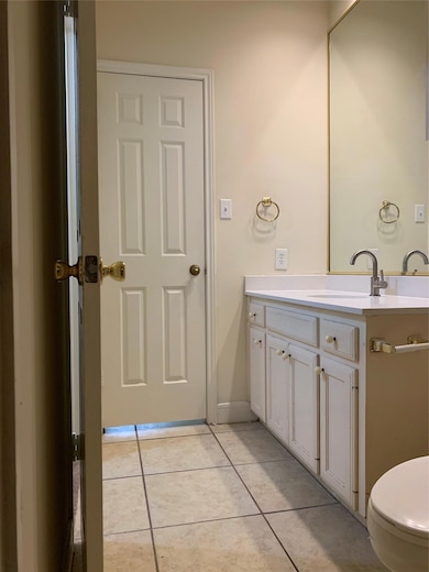 Bathroom featuring tile patterned flooring, toile
