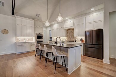 Kitchen featuring backsplash, appliances with stai