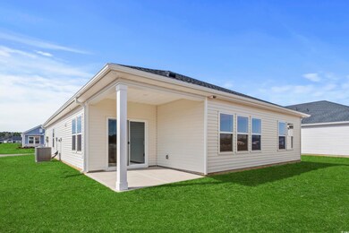 Back of house featuring cooling unit, a yard, and 