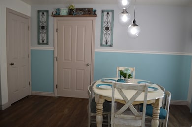 Dining area featuring dark wood finished floors and baseboards
