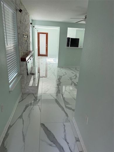 Bathroom with marble look tile flooring, a ceilin