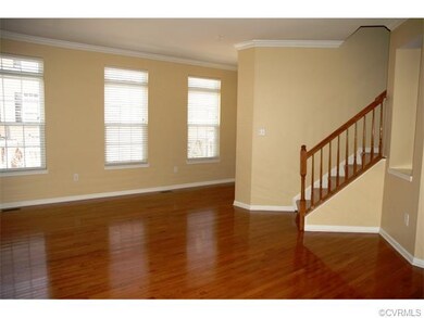 Sunny Living Room with hardwood floors & crown mou