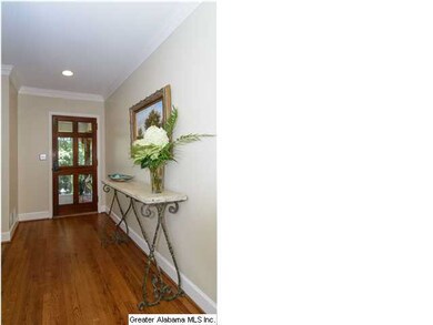 Entry from porch with glass paneled front door.