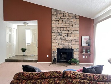 View of entryway, woodburning fireplace and sliding glass doors to patio