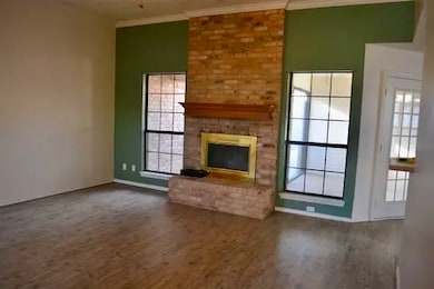 Unfurnished living room with a fireplace and dark wood-style floors