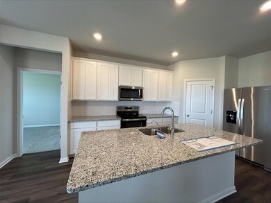 Kitchen with stainless steel appliances, dark woo