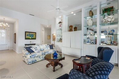 Living room featuring ceiling fan with notable cha