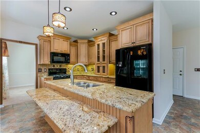 Beautful cabinets, granite countertops with bar area, all appliances remain. Refrigerator, microwave, dishwasher, range with convection oven and gas oven.