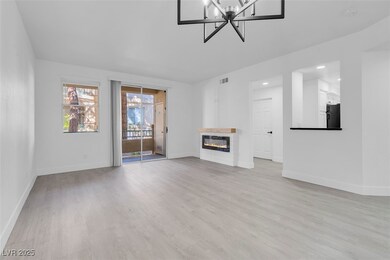 Living room with custom electric fireplace, and lu
