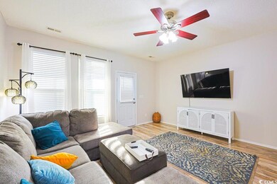 Living area featuring light wood finished floors and ceiling fan