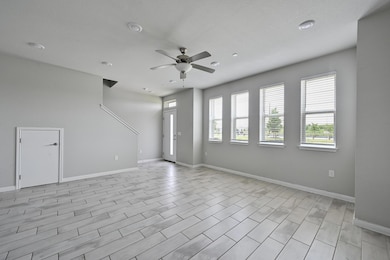 Unfurnished living room featuring baseboards, a c
