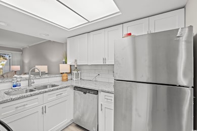 Kitchen with decorative backsplash, appliances wit