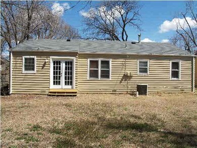 Rear view of the home with fresh exterior paint.