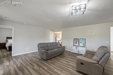 Living room with wood finished floors and baseboards
