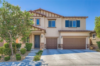 View of front of property with concrete driveway, a garage, stucco siding, and a tiled roof