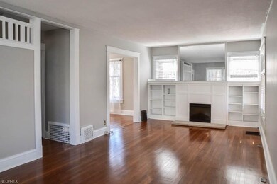Formal living room with wood flooring and a firepl