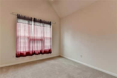 Carpeted spare room with baseboards and lofted cei