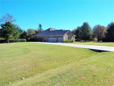 3 car garage. Note hedge. Black chain-link fence f