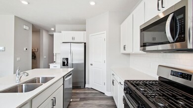 Stainless steel appliances along with quartz countertops are highlights of this open kitchen space. Not to mention the spacious walk-in pantry. *Photos are of model home, finishes in actual home may vary.