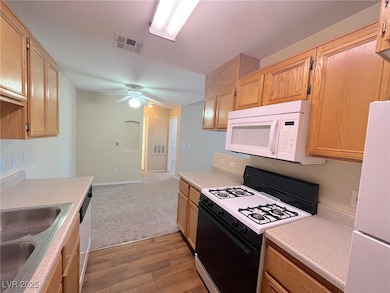 Kitchen with visible vents, a sink, light countert