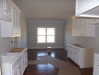 The kitchen has a spacious Breakfast Room and  features white custom cabinetry with granite countertops.