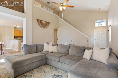 Living room featuring light carpet, high vaulted c