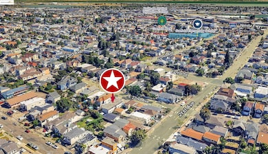 Aerial view of property and surrounding area with nearby suburban area