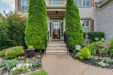Welcoming covered porch with breath taking landscaping brings elegance to this beautiful five bedroom home. 