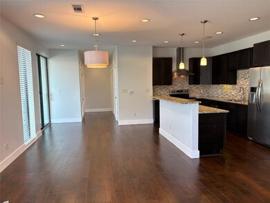 Kitchen with wall chimney range hood, appliances 