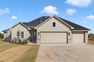 View of front of house with a garage and a front y