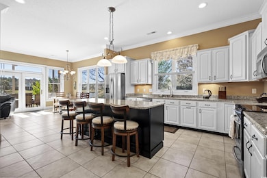 Kitchen featuring white cabinets, appliances with 