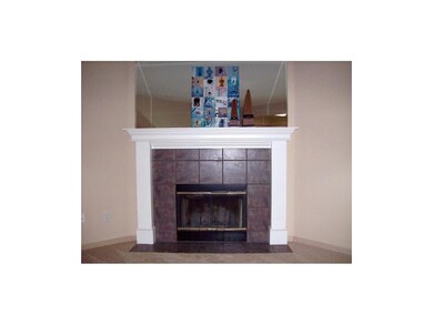 Lovely wood-burning fireplace adds warmth to livin
