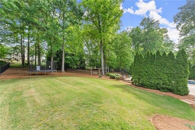 View of yard with fence and a trampoline