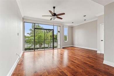 Living room overlooking balcony and tennis courts