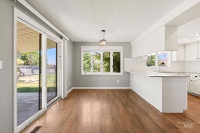 Unfurnished dining area featuring hardwood / wood-style floors and a textured ceiling