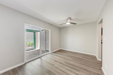 Spare room with wood finished floors, ceiling fan